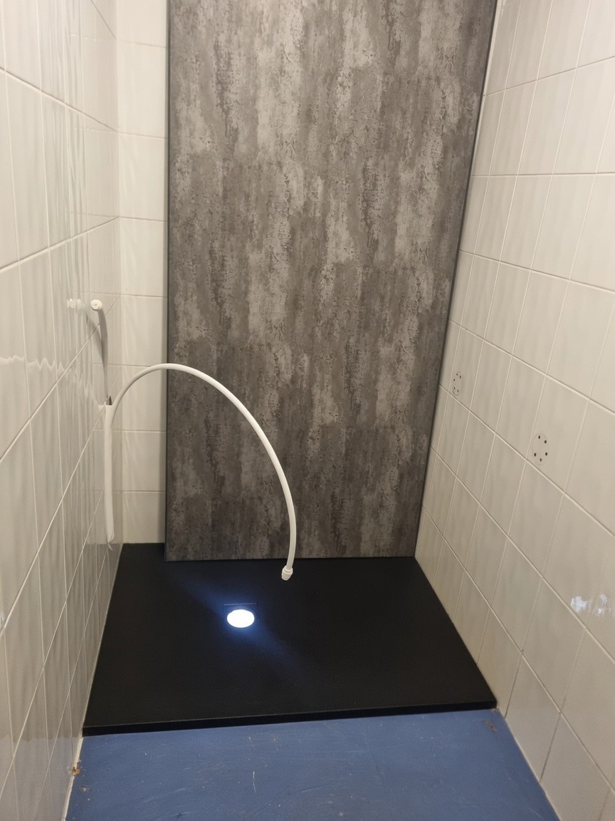 Shower tray and wall panel install in progress